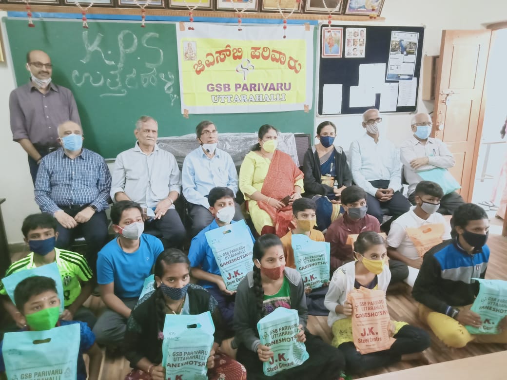 Distribution of school books to High school students at Government High School Uttarahalli