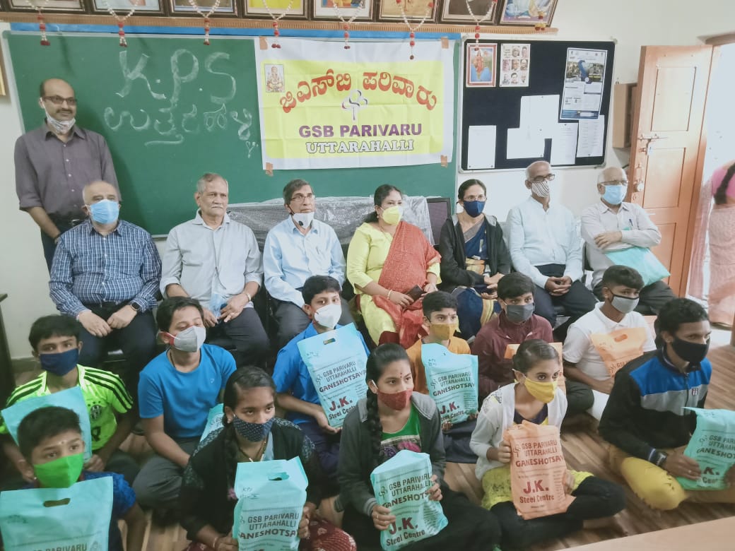 Distribution of school books to High school students at Government High School Uttarahalli