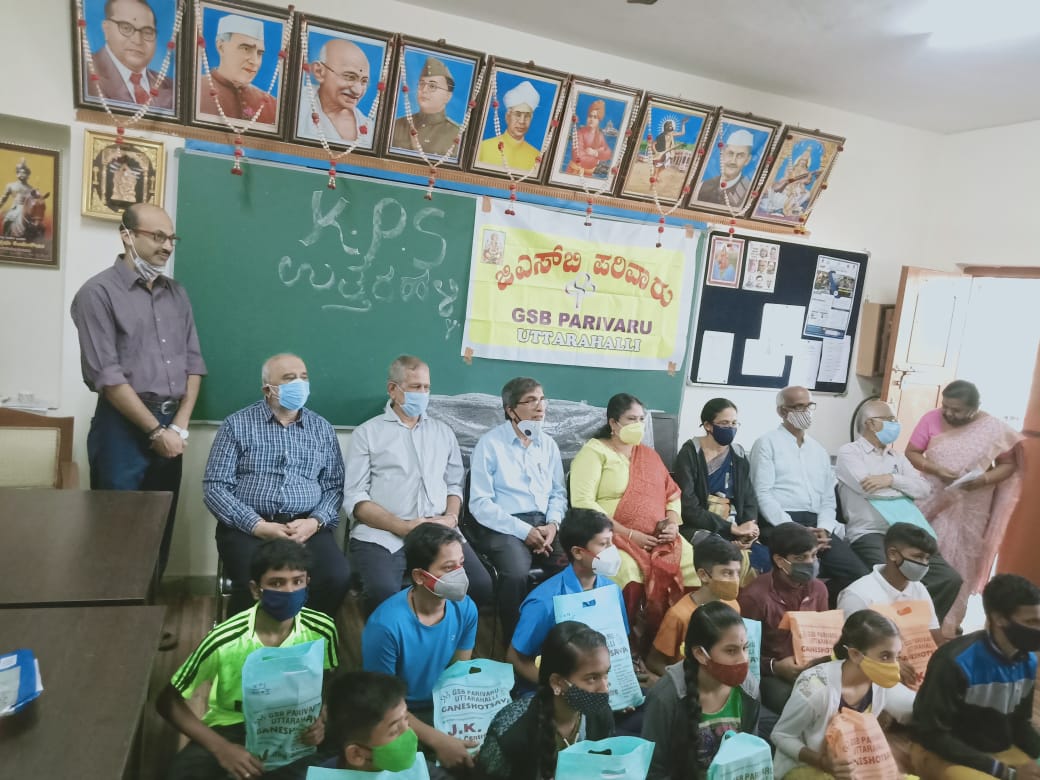 Distribution of school books to High school students at Government High School Uttarahalli